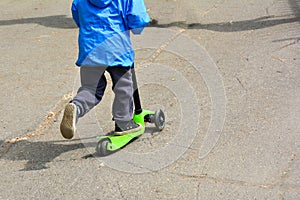 Child on a Scooter. At public park. Close Up Of The Feet On The Scooter, Urban Sports And Fashions photo