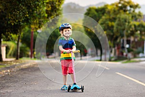 Child on scooter in summer. Kids skate
