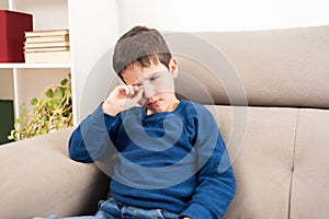 child scratching itchy eye
