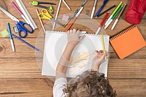 Child scribbling in a notebook. photo