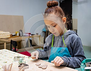 Child sculpts clay from hearts as a gift to mom