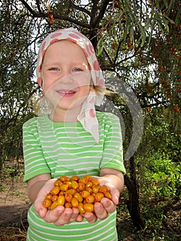 The child with sea-buckthorn berries