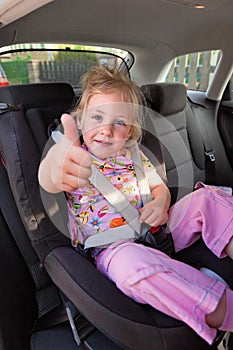 Child seated in child seat in the car