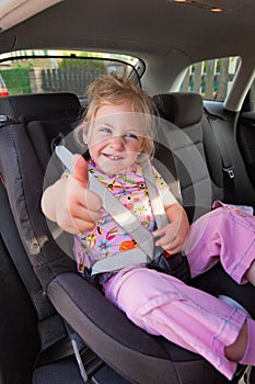 Child seated in child seat in the car