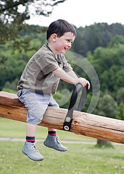 Child on seesaw photo