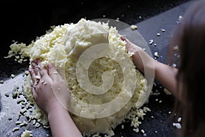 A child shaping the potato dough. at home