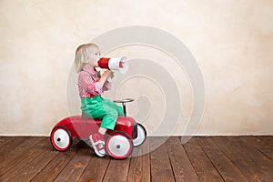 Child shouting through vintage megaphone