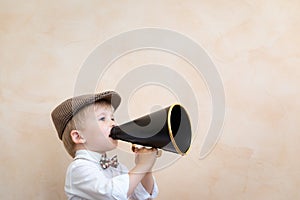 Child shouting through vintage megaphone