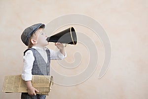 Child shouting through vintage megaphone