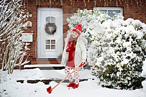 Child shoveling winter snow. Kids clear driveway.