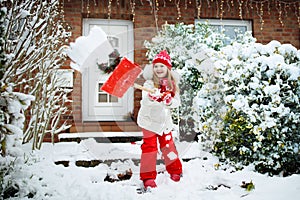 Child shoveling winter snow. Kids clear driveway.