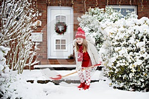 Child shoveling winter snow. Kids clear driveway