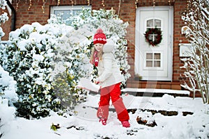 Child shoveling winter snow. Kids clear driveway