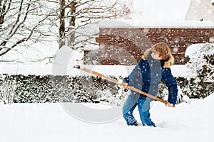 Child shoveling winter snow. Kids clear driveway