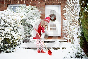 Child shoveling winter snow. Kids clear driveway