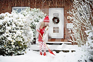 Child shoveling winter snow. Kids clear driveway