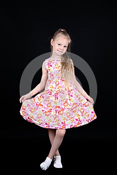 Child showing dress isolated on black background