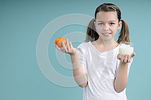 Child showing orange and milk