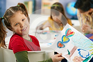 Child showing painting in art class