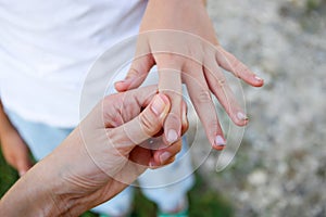 The child shows his hands with dirt under his nails