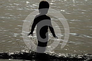 Child silhouette at sea