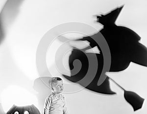 Child with silhouette of witch and jack o lantern photo