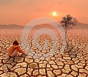 Child sit on cracked earth