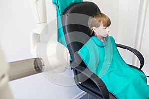 Child sits in the office of the radiologist
