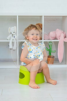 The child sits on the potty. Selective focus.