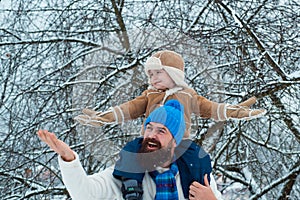 Child sits on the shoulders of his father. Christmas holidays and winter new year with father and son. Father and son