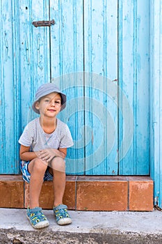 Child sitting at front door