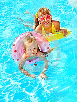 Child sitting on inflatable ring..