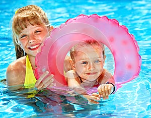 Child sitting on inflatable ring..