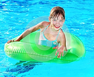 Child sitting on inflatable ring .