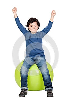 Child sitting on a pilates ball