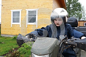 Child sitting on quad bike