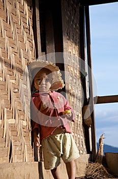Child sitting on the step in the village