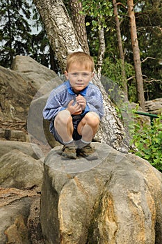 Child sitting on stone