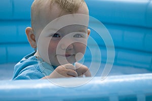 Child sitting in the swimming pool