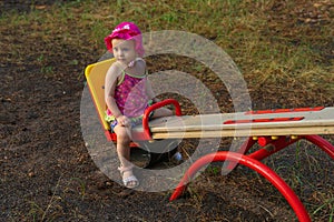 Child sitting on teeter-totter