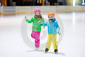 Child skating on indoor ice rink. Kids skate