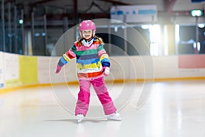 Child skating on indoor ice rink. Kids skate