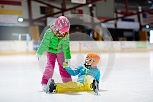 Child skating on indoor ice rink. Kids skate