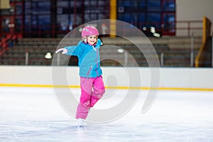 Child skating on indoor ice rink. Kids skate