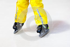 Child skating on indoor ice rink. Kids skate