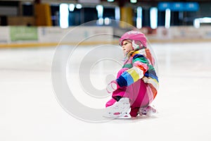 Child skating on indoor ice rink. Kids skate