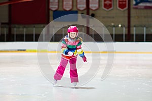 Child skating on indoor ice rink. Kids skate