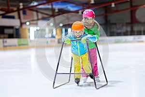 Child skating on indoor ice rink. Kids skate