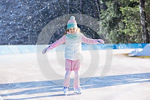 Child skating on natural ice. Kids with skates.