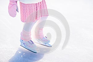 Child skating on natural ice. Kids with skates.